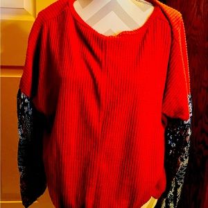 Red top with navy paisley print sleeves